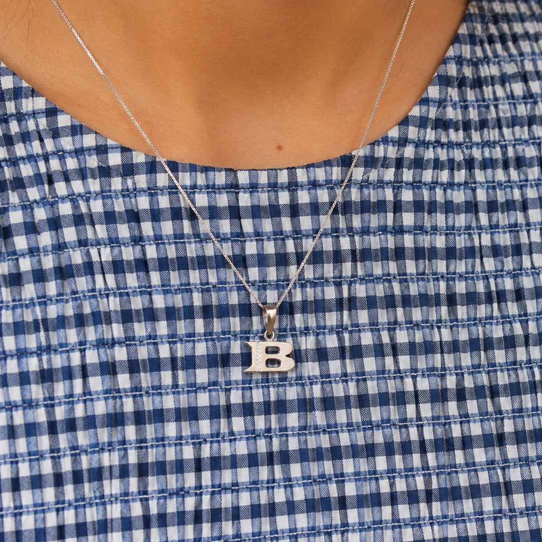 Initial diamond pendant